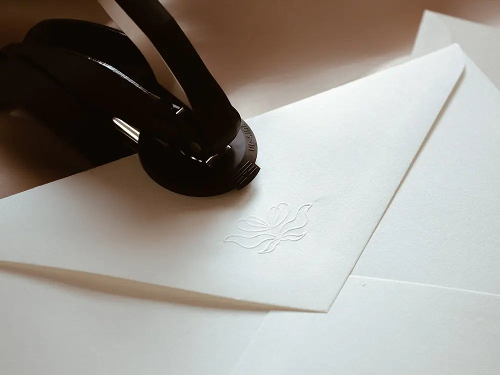 Sello en golpe en seco para crear un relieve elegante y sin tinta, ideal para personalizar invitaciones, certificados y documentos de lujo con un toque sofisticado.