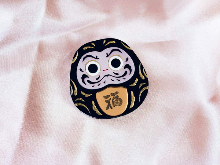 Daruma amuleto japonés Negro con los dos ojos pintados